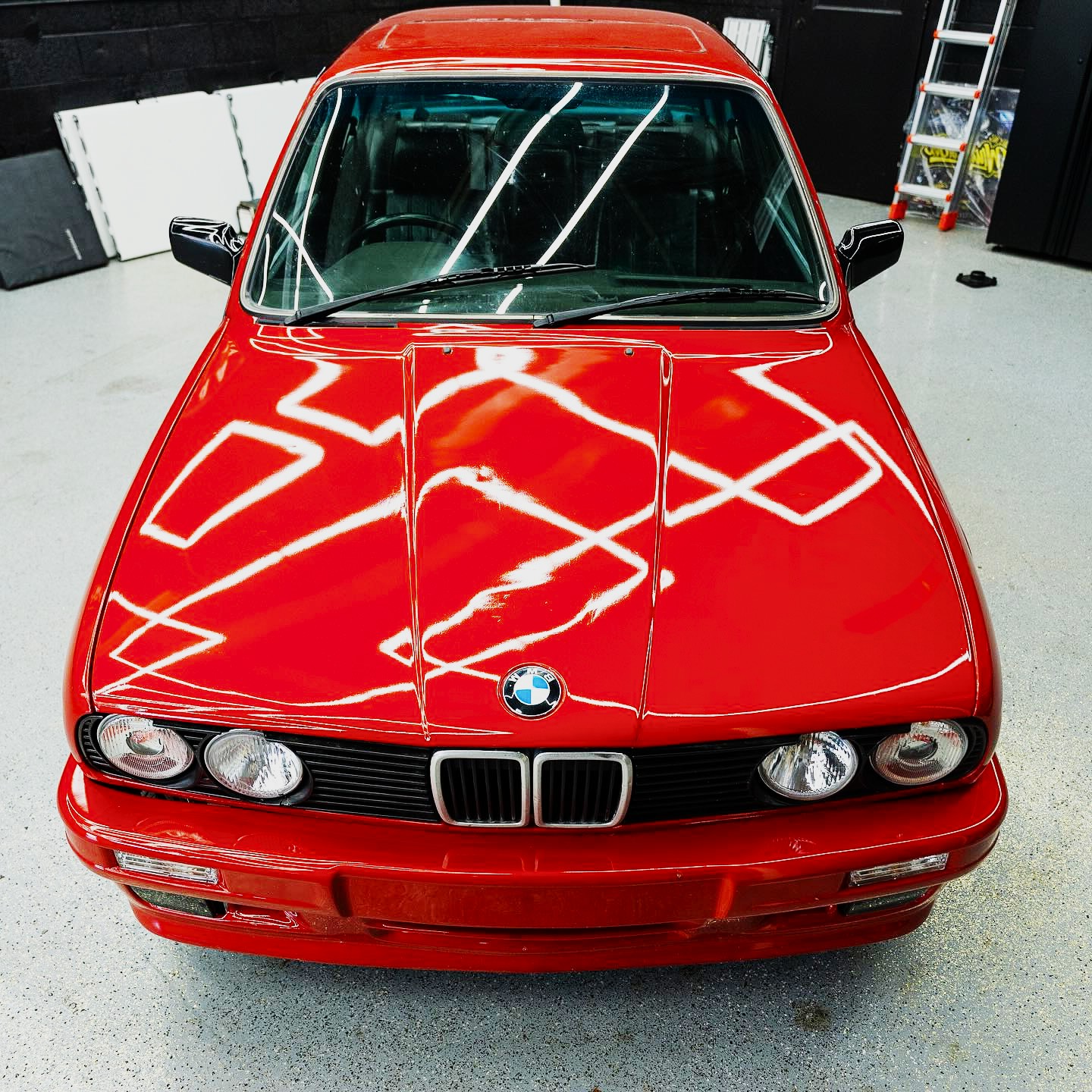 Gloss red BMW E30 after paint correction in the bay