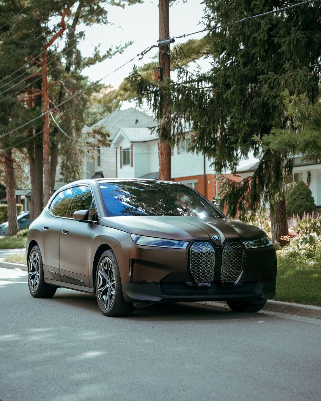 Matte bronze BMW iX on the street